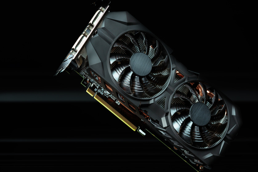 Close-up of a graphics card with dual fans against a black background